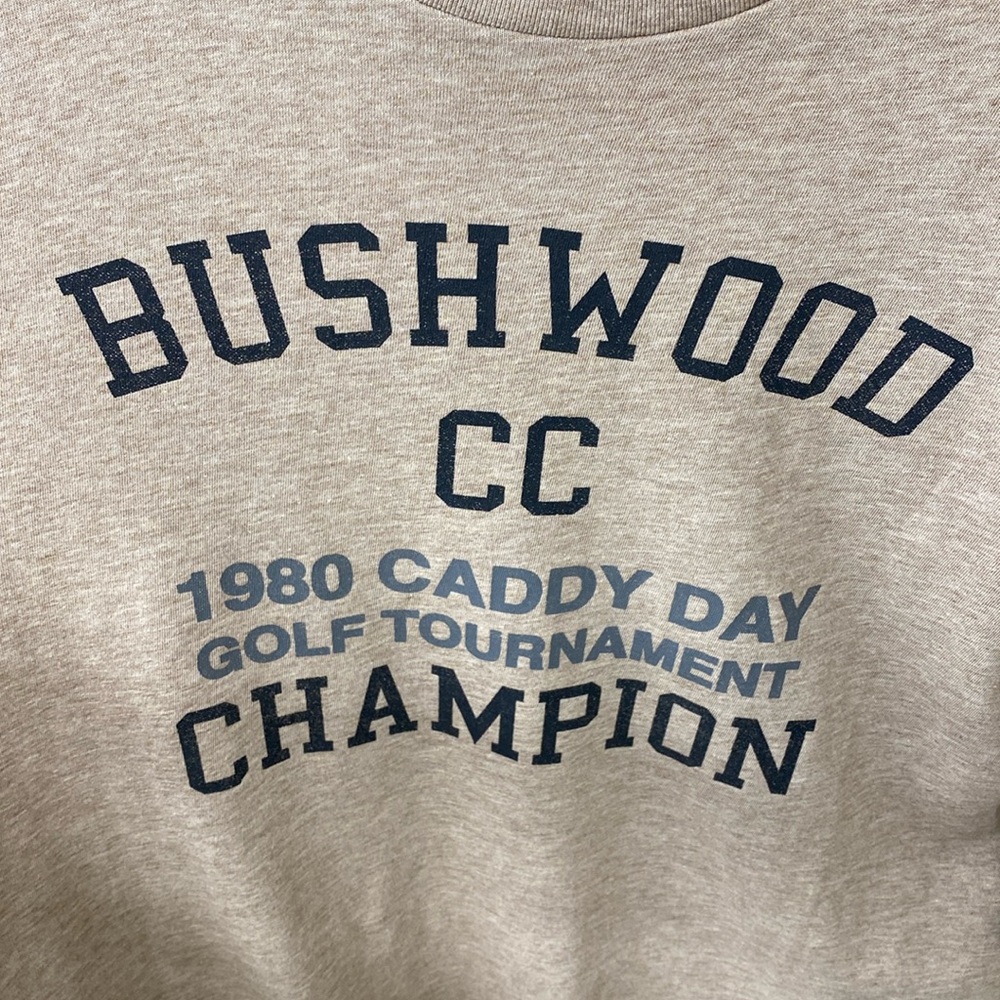 Travis Mathew NWT Bushwood CC tee shirt. Medium. Tan color tee.